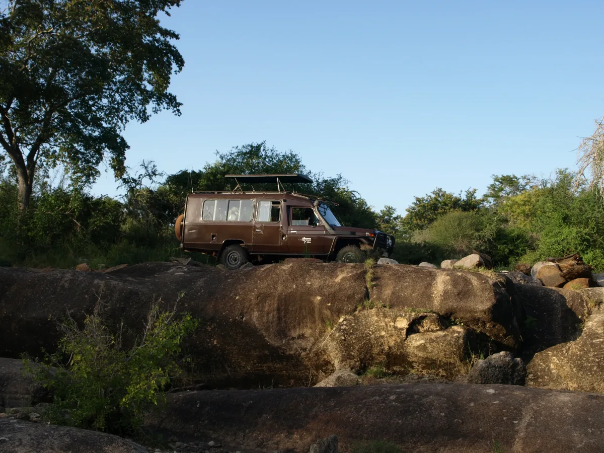 Safari vehicle parked on granite rocks in Mkomazi National Park